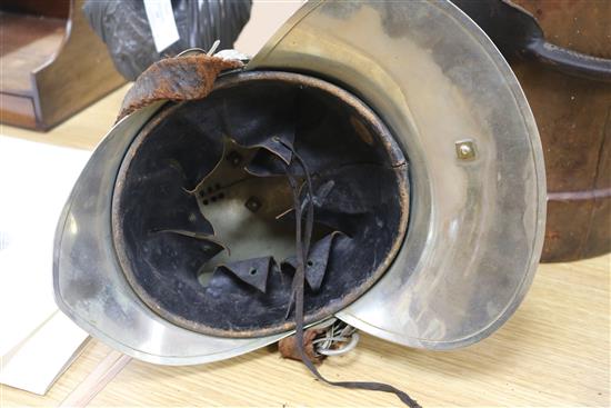 A firemans helmet and a leather belt